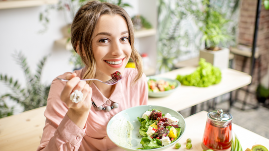 A woman eating a salad - clean and healthy