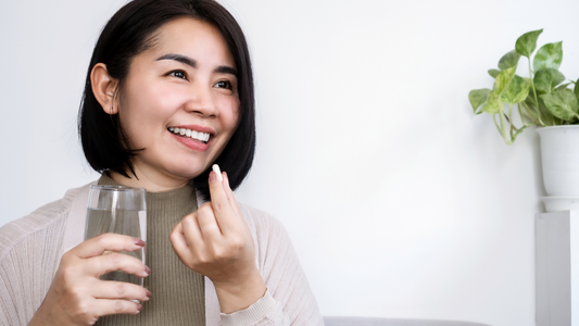 Portrait of an Asian woman taking supplements.